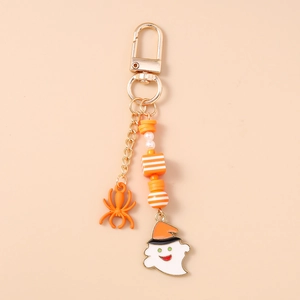 Detail showing golden D-clasp, striped beads, white ghost and orange spider pendants