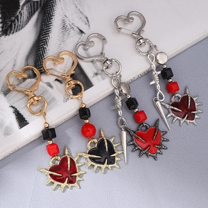 Gothic punk heart sword keychains in gold and silver finish with thorny enamel charms