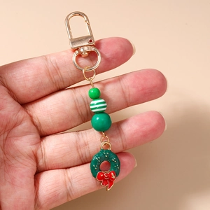 Christmas beaded keychain featuring green beads and a festive wreath with a red bow