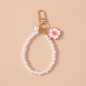 Fashion pearl keychain featuring a pink enamel cherry blossom charm and golden clasp