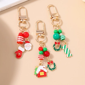 Trois porte-clés de Noël festifs avec Père Noël et breloques en émail coloré