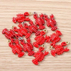 Detailed macro view of vivid red enamel lobster charms for DIY jewelry making and crafts