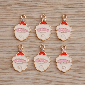 Detail showing Santa Claus alloy pendants with red enamel and small rhinestone accents