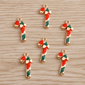 Detailed macro of six candy cane pendants with red and green enamel and gold alloy edges