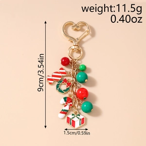 Dettaglio portachiavi natalizio da 9cm con dimensioni e peso su sfondo beige neutro