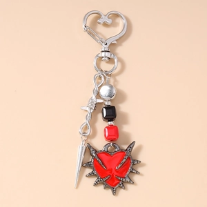 Gothic heart keychain detail with red enamel center, black beads and silver metal thorns
