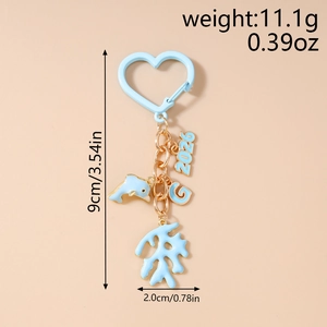 Detail of light blue heart carabiner with dolphin, 2026, and letter G charms