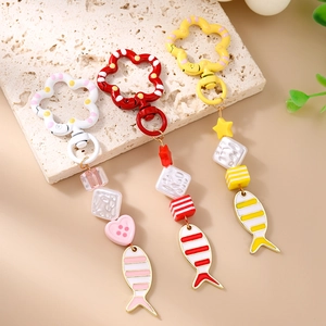 Fashionable goldfish beaded keychain with heart and star charms in warm pastel colors