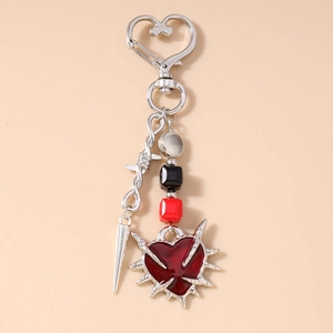Detailed view of Gothic punk heart keychain with silver spikes and red enamel heart pendant