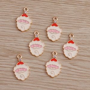 Detailed macro view of 6 enamel Santa Claus charms with rhinestones for jewelry making