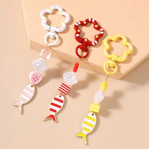 Close-up of cute beaded fish keychains with colorful resin cubes and flower clasps
