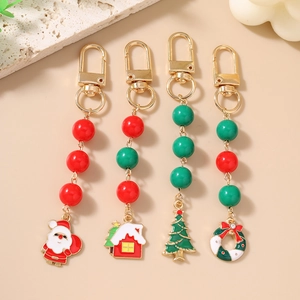 Christmas keychain set with Santa, house, and tree pendants in festive red and gold