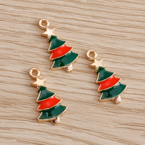 Close-up of DIY Christmas tree charms with red and green enamel and gold star detail