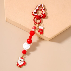 Detailed shot of Christmas bead keychain with Santa pendant and red glove charm