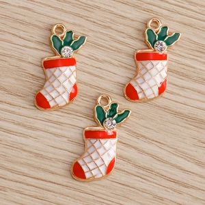 Detailed macro view of three Christmas sock charms with red green enamel and rhinestones