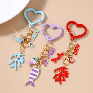 Marine theme keychains with coral and tropical fish charms in gold metal finish