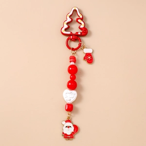 Close-up of Christmas pearl bead keychain with red glove and Santa Claus pendant