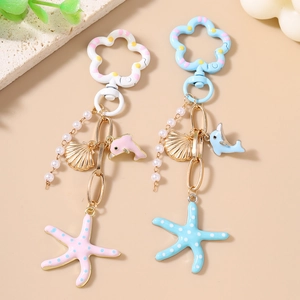 Porte-clés tendance perles et étoile de mer avec dauphin en rose et bleu