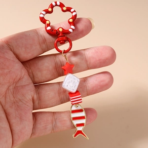 Red flower clasp keychain featuring striped fish pendant and colorful resin beads