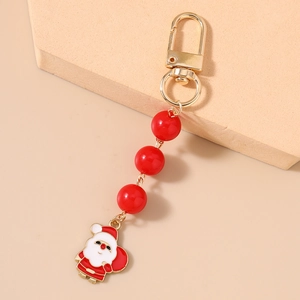 Detailed close-up of a Christmas keychain with golden lobster clasp and Santa pendant