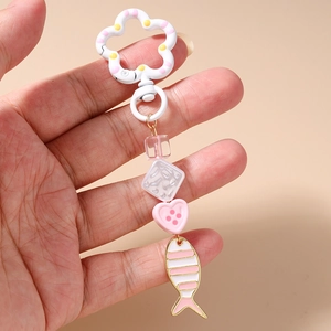 Detailed close-up of a pink goldfish enamel pendant with floral carabiner and crystal beads