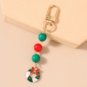 Close-up of Christmas wreath keychain with colorful beads and golden lobster clasp detail