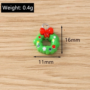 Detailed macro view of 16x11mm Christmas wreath charms with red bow for DIY jewelry