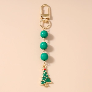Detail of Christmas tree keychain with gold metal clasp and glossy green beads decoration