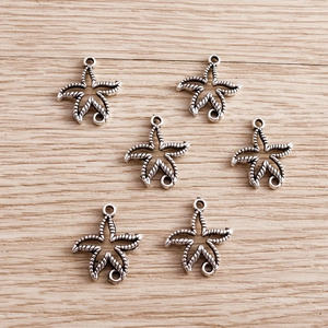 Set of six antique silver starfish charms with detailed radial texture for DIY jewelry making