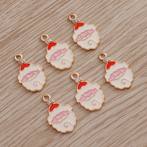 Detailed view of six colorful enamel Santa Claus charms with rhinestone hanging loops