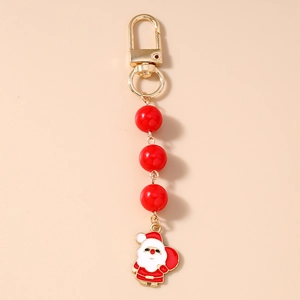 Detail of Christmas keychain with Santa charm, red beads and gold D-ring buckle