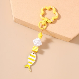 Close-up of a creative goldfish keychain with yellow cube beads and flower clasp