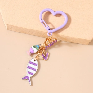 Detailed view of a purple heart-shaped carabiner keychain with 2026 and V charms