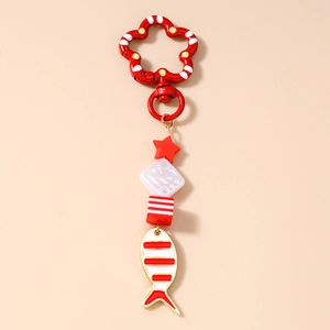 Detail view of goldfish keychain with red cube beads and flower shaped clasp