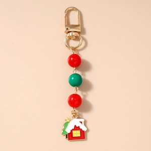 Detailed macro view of Christmas house charm keychain with festive red and green beads