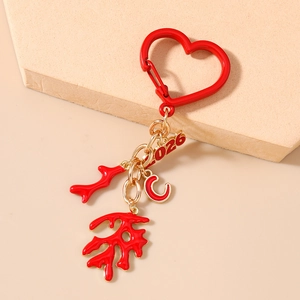 Detail view of 2026 heart carabiner keychain with red coral charms and letter C