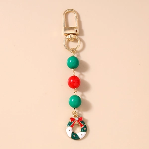 Detail of Christmas wreath keychain with red and green beads on gold lobster clasp