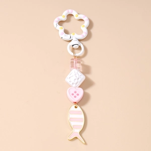 Detail of beaded keychain with pink flower clasp and striped fish pendant charm