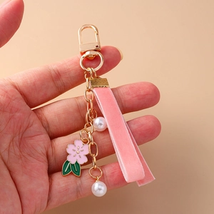 Elegant cherry blossom keychain with pink velvet ribbon, imitation pearl and gold metal