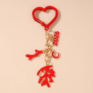 Detailed view of 2026 and C pendants on red heart keychain with coral charms
