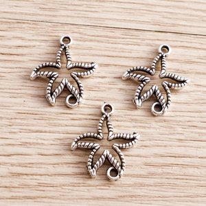 Close-up of three starfish alloy pendants with vintage rope texture and double rings