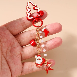 Festive Christmas keychain with Santa, elk, and pearl charms in classic red and gold