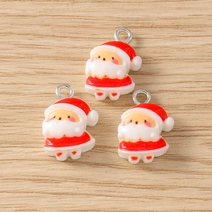 Detailed close-up of three cute resin Santa Claus charms for DIY jewelry making