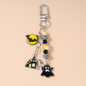 Detail of Halloween keychain with bat moon, spooky ghost, and haunted castle charms