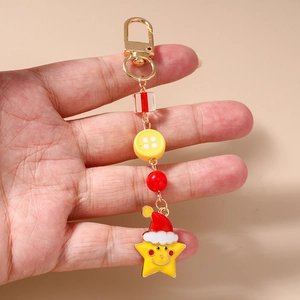 Detailed macro view of Christmas hat star keychain with golden spring buckle and beads
