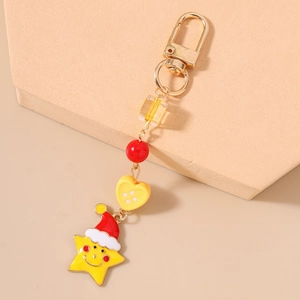 Detail of Christmas star keychain with red Santa hat and colorful decorative beads