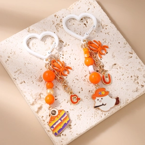 Halloween keychain with ghost, octopus, and eyeball cake charms on stone display