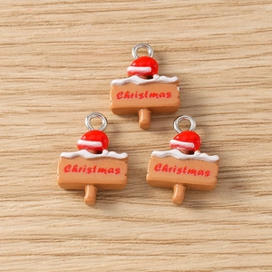 Close-up of three resin Christmas signpost pendants with red Santa hats and silver loops