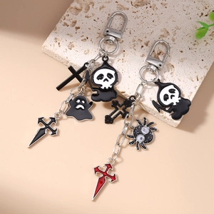 Gothic Halloween keychains with grim reaper, ghost, and spider charms on stone