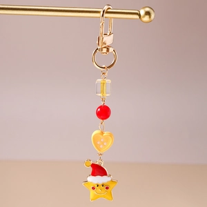 Detail of Christmas star keychain with red hat, gold clasp, and colorful beads